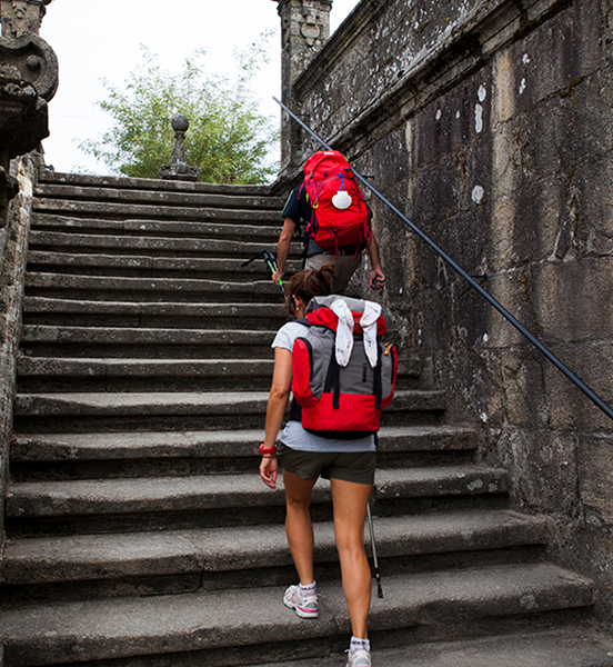 Pilgrims climbing stone steps on Camino
